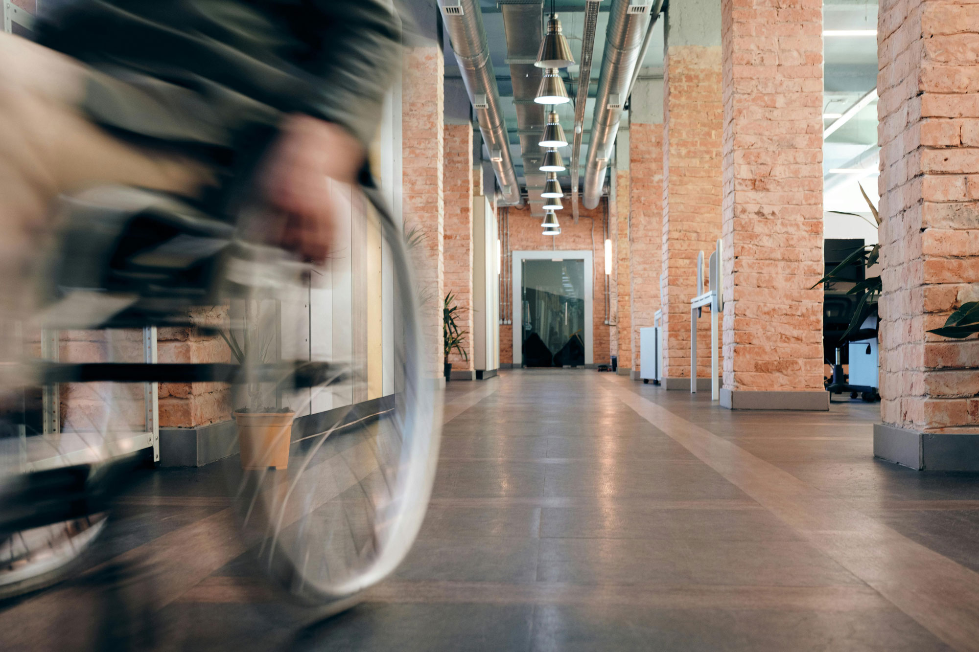 Wheelchair bound person rolling down and past at speed.